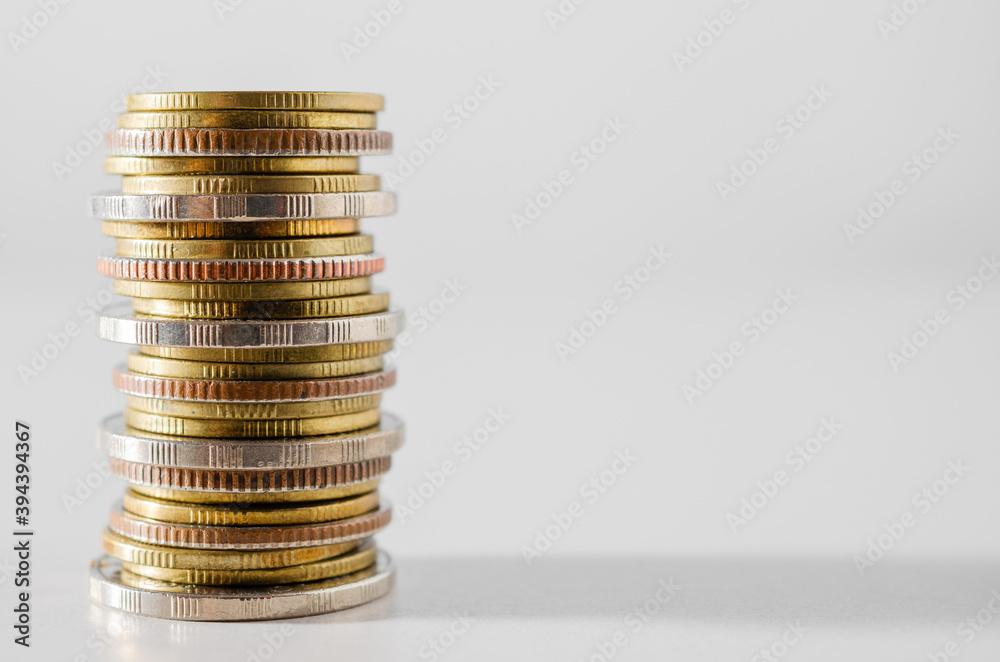 row of coin stack growing pile on white background for money saving and investment business financial and banking concept. row of coin stack growing pile on white background for money saving and investment business financial and banking concept.