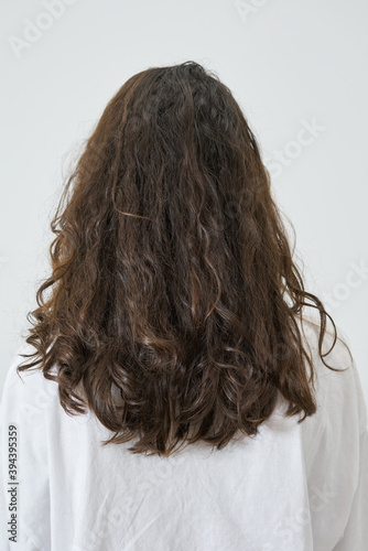 Dry and frizzy natural curly hair that needs hydration. Natural curls before salon treatment. close up, soft focus photo