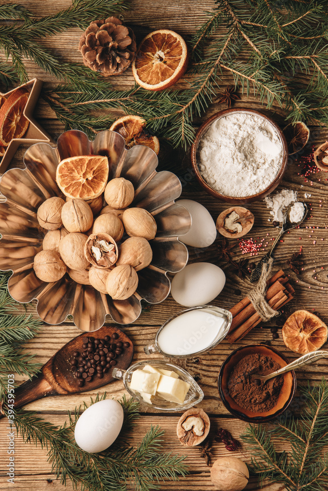  Ingredients for making christmas cupcake on wooden background, top view, vertical photo