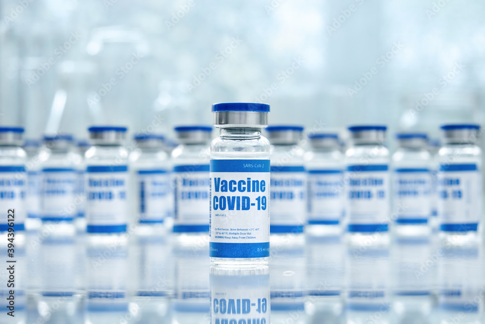 Covid 19 corona virus vaccine vial bottles for intramuscular injections on medical pharmaceutical industry background. Coronavirus cure manufacture, flu treatment drug pharmacy production concept.