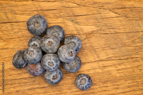 handful of fresh blueberries on a farm table