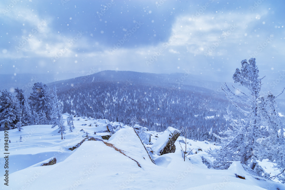 Sheregesh ski resort in Russia, located in Mountain Shoriya, Siberia. Winter landscape, trees in snow and blue sky.