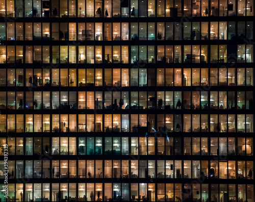 office building facade - business people working at night