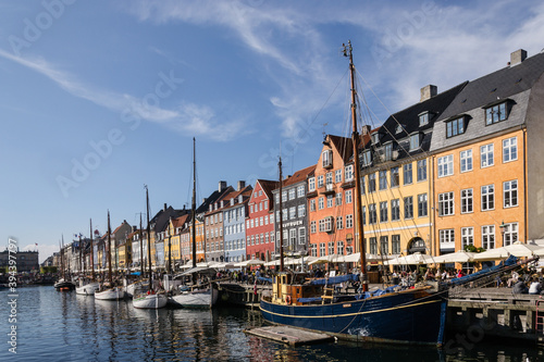 Scenic summer view of Nyhavn pier with colorful buildings and boats in Old Town of Copenhagen, Denmark