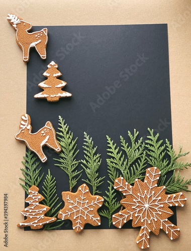 Christmas black backgroudn with homemade cookies and fir top view. new year wallpaper with copyspace