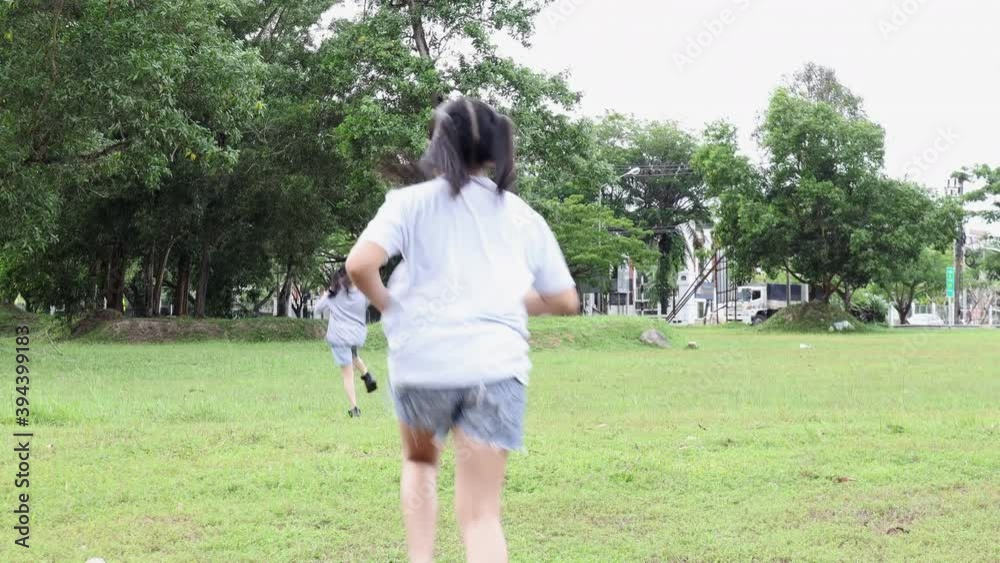 4K Little girl together run in the park. Happy family people in the park concept. Two sisters playing catch-up run. Child fun running in green meadow. 4K Little girl together run in the park. Happy family people in the park concept. Two sisters playing catch-up run. Child fun running in green meadow.