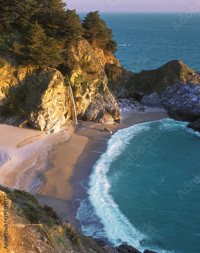 Fototapeta Naklejka Na Ścianę i Meble -  McWay Falls at Julia Pfeiffer State Park, California. On a particularly clear evening in March the sunset shone through the opening in the cove to light up the falls, McWay Falls