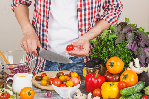 Woman cooks at the kitchen, body part, blurred background