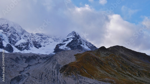 Panoramic view of the eastern flank of the majestic Ortler mountains in the Alps with glacier Suldenferner on a cloudy day in autumn near Sulden in South Tyrol  Italy in autumn season.