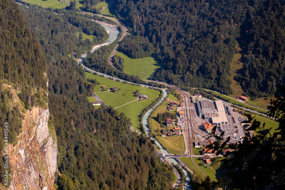 High angle view from Hunnenflue on the curvy run of the (white) Lütschine river and the railway station of Zweilütschinen. Jungfrau region, Bernese Oberland, Switzerland