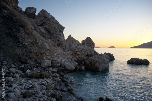 Beautiful sea view with rocks and cliffs at sunset. View of huge stones in ocean. Picturesque rocky landscape.