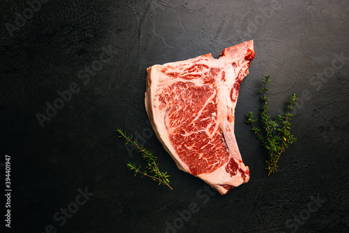 Raw fresh meat T-bone beef Steak on black background, top view