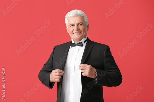 Stylish senior man on color...