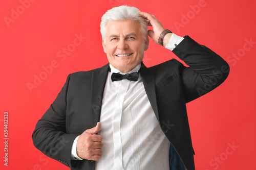 Stylish senior man on color...