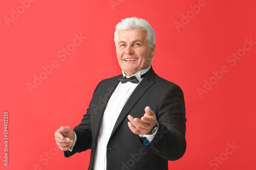 Stylish senior man on color...