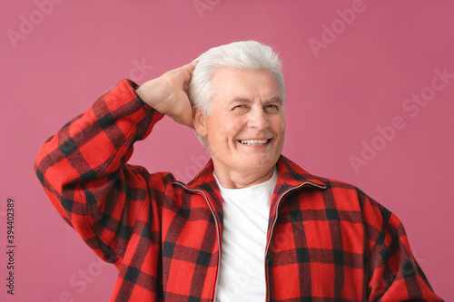 Stylish senior man on color...