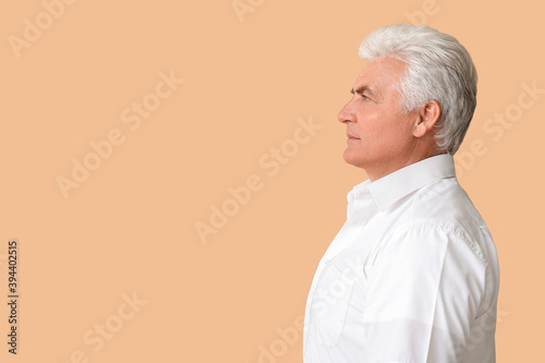 Stylish senior man on color...