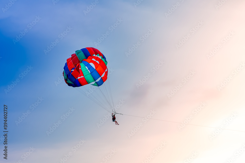 Colorful parachute in the sky on beautiful sunset Colorful parachute in the sky on beautiful sunset