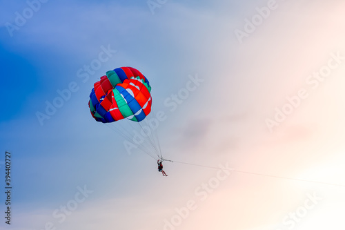 Colorful parachute in the sky on beautiful sunset