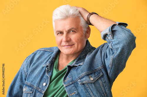 Stylish senior man on color...