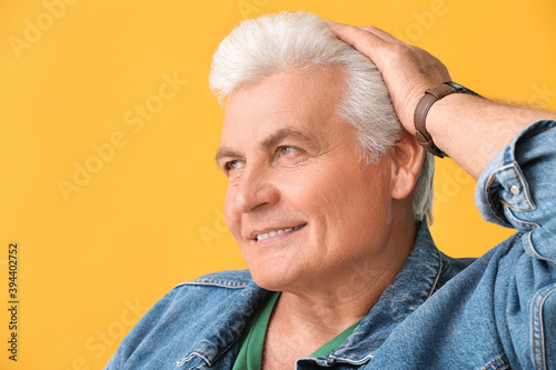 Stylish senior man on color...