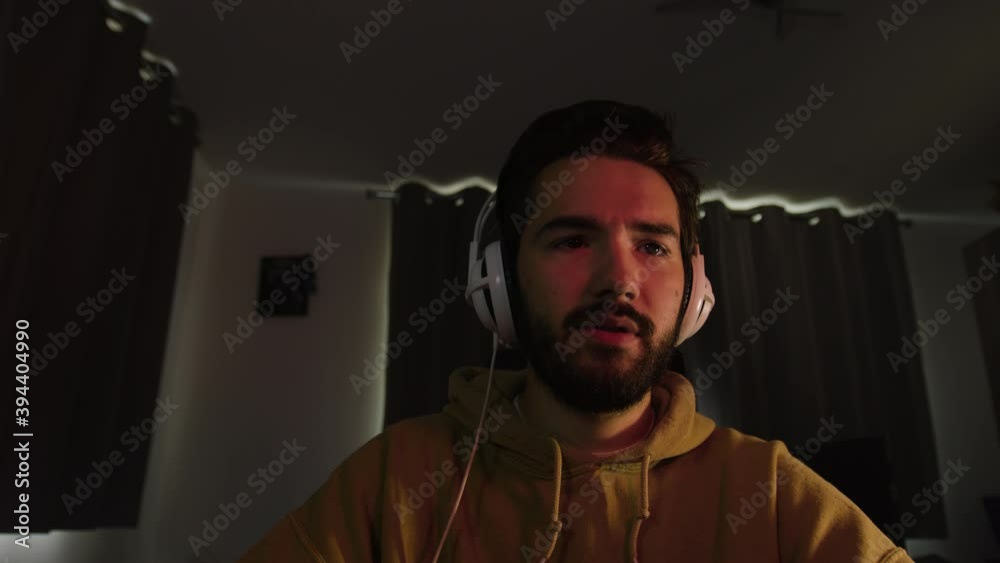 Male working on a pc, looking confused and taking a sip from a mug Male working on a pc, looking confused and taking a sip from a mug