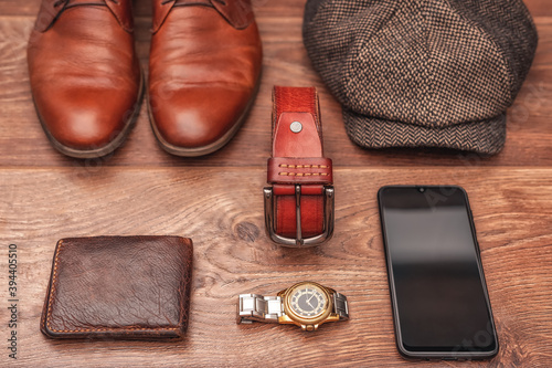 Men's clothing and accessories on a wooden background in warm colors