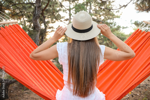 Relaxing woman in straw hat...