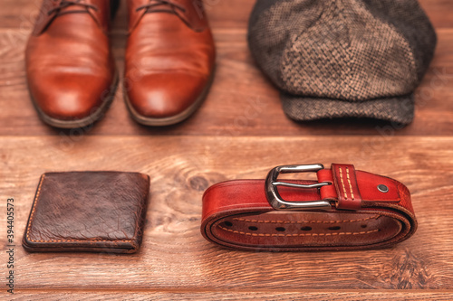 Men's clothing and accessories on a wooden background in warm colors