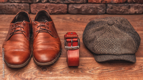 Men's clothing and accessories on a wooden background in warm colors