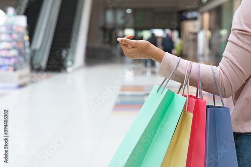 Black Friday Sales. Unrecognizable African Woman Walking In Mall With Shopper Bags