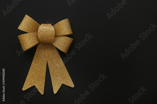 Golden bow on dark background