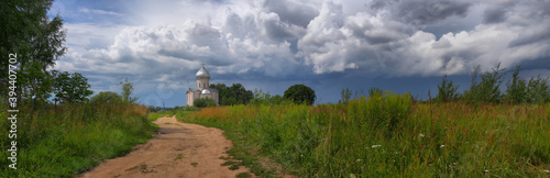 Panorama of the Russian landscape with the road to the temple photo