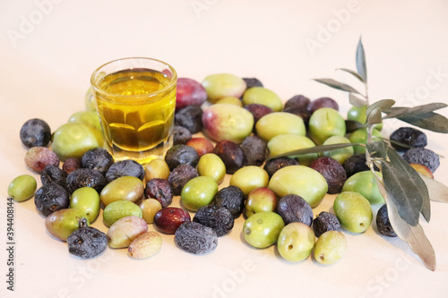 Olive oil with olives on white background. Freashly gathered, raw and organic.