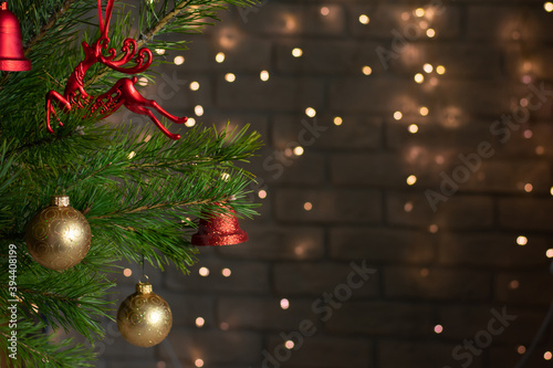 Christmas tree is decorated with gold and red toys photo