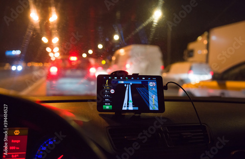 Tablet with a navigator in the car on the background of a night city