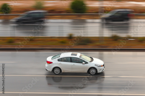 White car driving fast on highway with motion blurred background © YALÇIN KAHYA