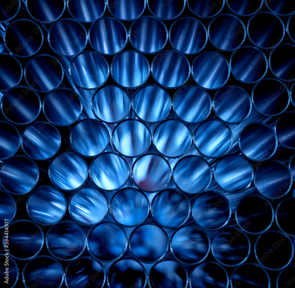 © romaset - Abstract background of steel pipes stacked on a pallet