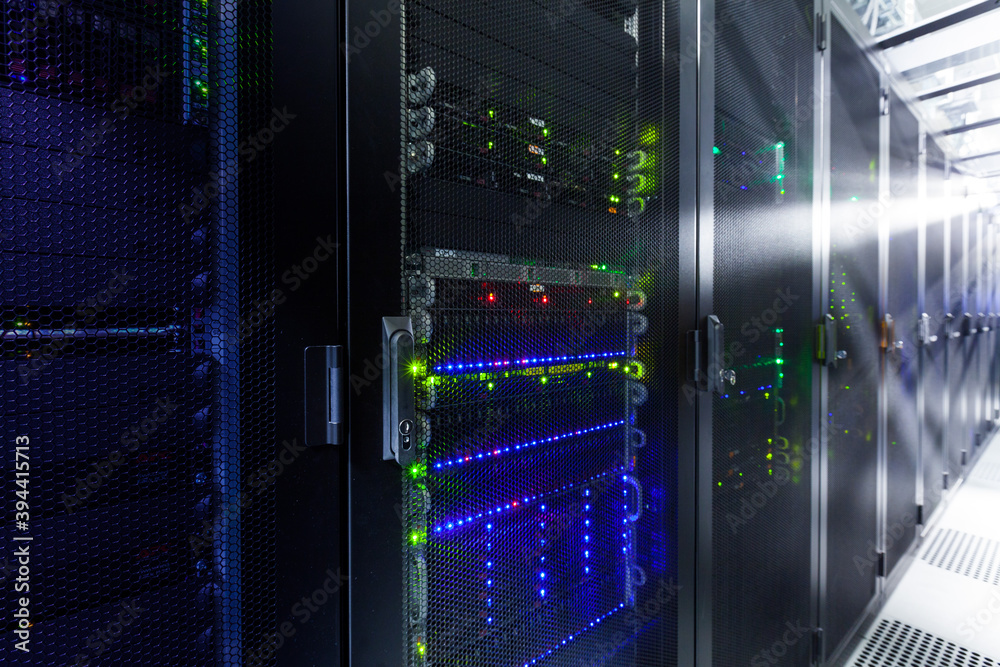 Network servers in a data center. Tier III carrier neutral data center. Server rooms.