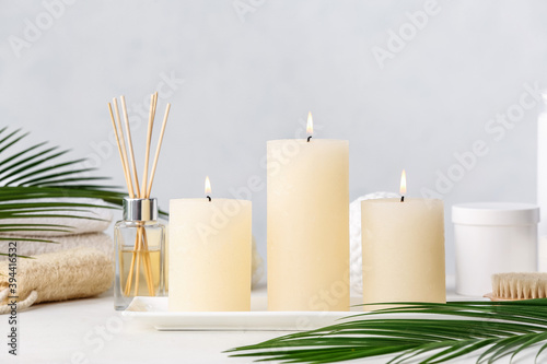 Beautiful aroma candles on table in bathroom