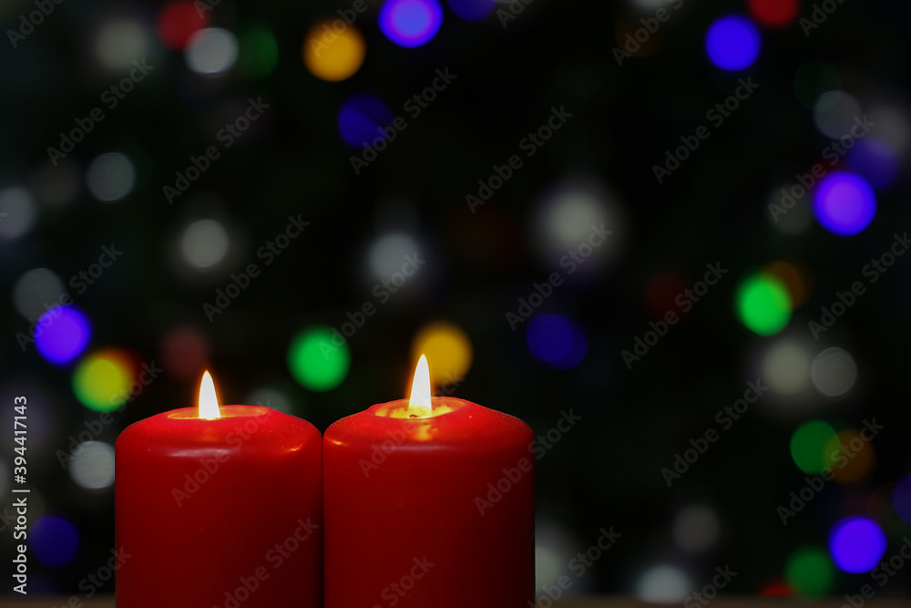 Burning red advent candles on dark background Burning red advent candles on dark background