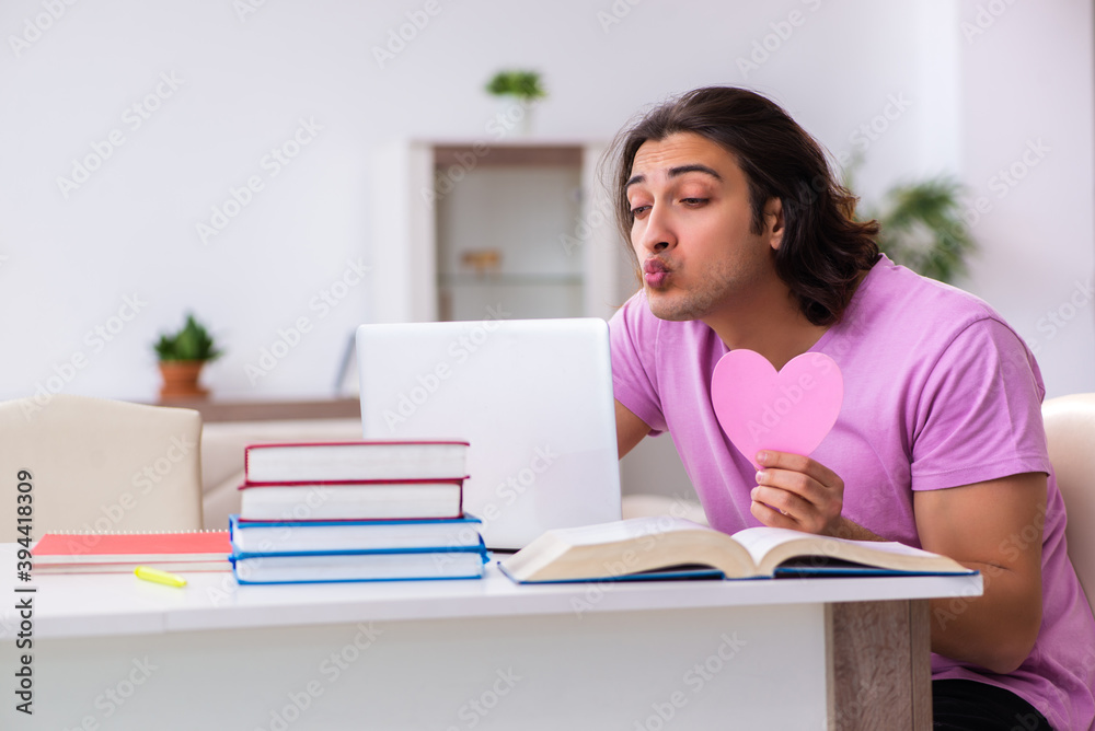 Male student in love preparing for exams at home Male student in love preparing for exams at home