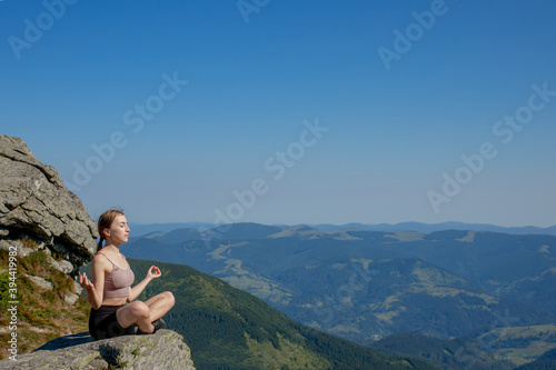 Yoga, Meditation. Woman balanced, practicing meditation and zen energy yoga in mountains. Woman doing fitness exercise sport outdoors in morning. Healthy lifestyle concept.
