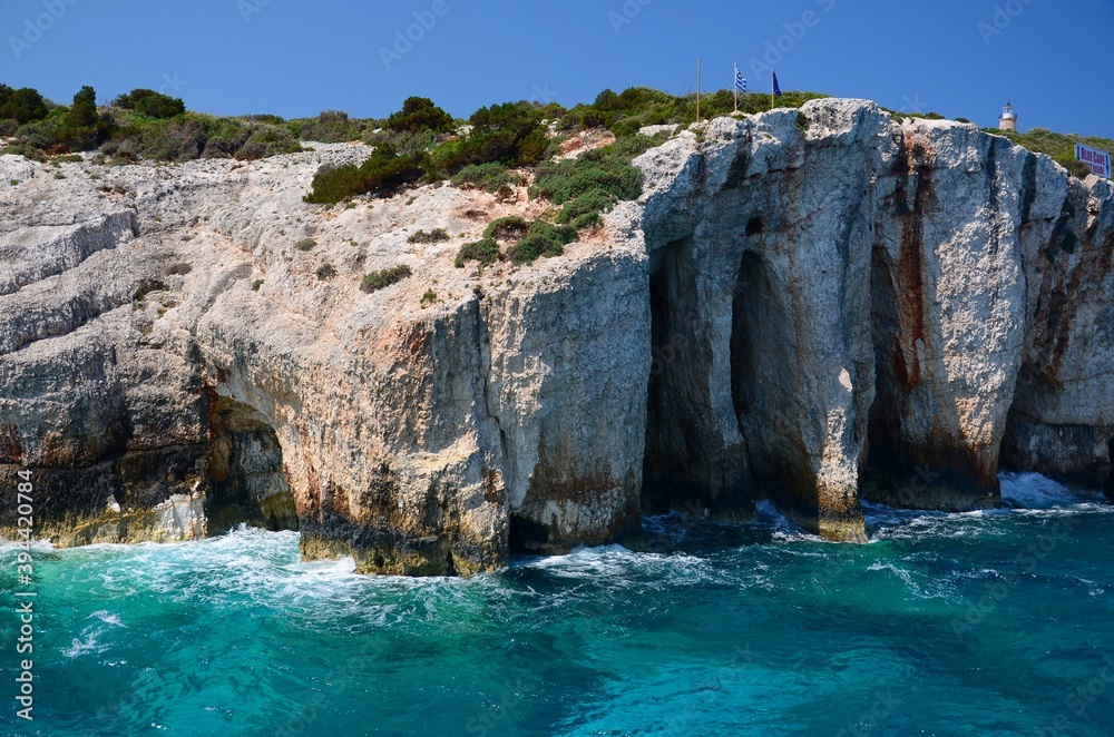 Blue caves on Zakynthos island. Crystal clear water, boat trip around the island of Zakynthos. Caves on the coast created by the sea. Limestone cliffs.