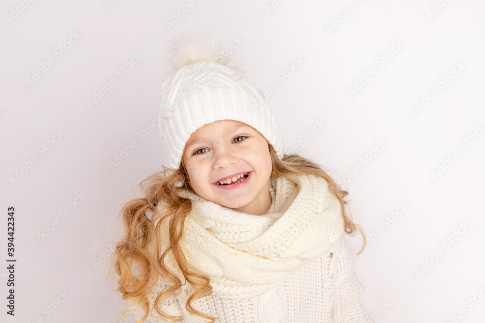 happy baby girl in warm hat and sweater on white isolated background, space for text happy baby girl in warm hat and sweater on white isolated background, space for text