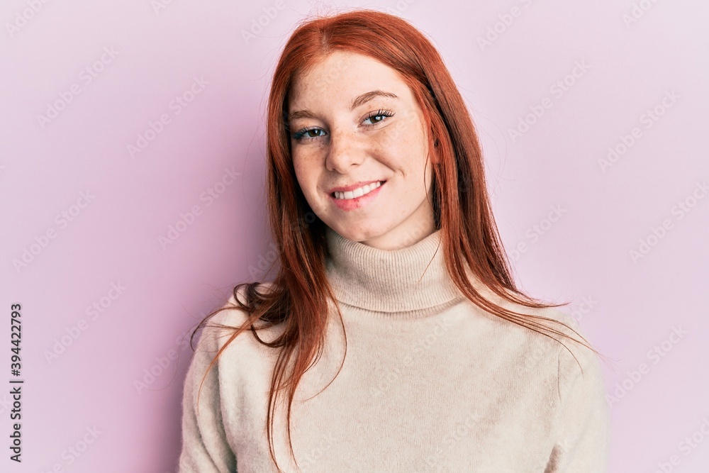 Obraz premium Young red head girl wearing turtleneck sweater with a happy and cool smile on face. lucky person.