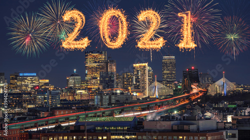 2021 written with Sparkle firework with Multicolor Firework Celebration over Scene of Boston skyline cityscape which can see Zakim Bridge and Tobin Bridge, Happy new year and merry Christmas concept photo