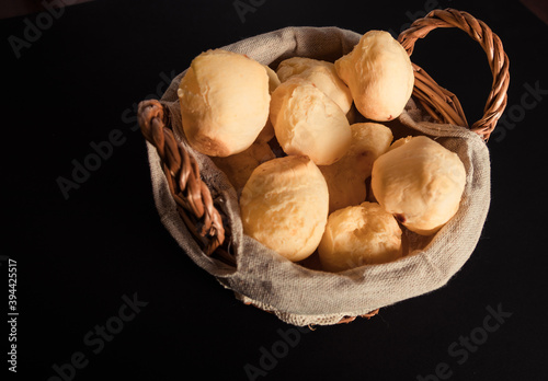 Brazilian cheese bread 'pao de queijo' on basket, homemade cheese buns. typical snack from minas gerais. Black Background