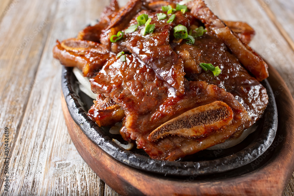 A view of a skillet plate of galbi, which is marinated Korean beef