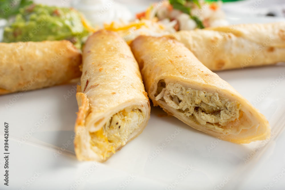 A closeup view of several flautes on a plate. A closeup view of several flautes on a plate.